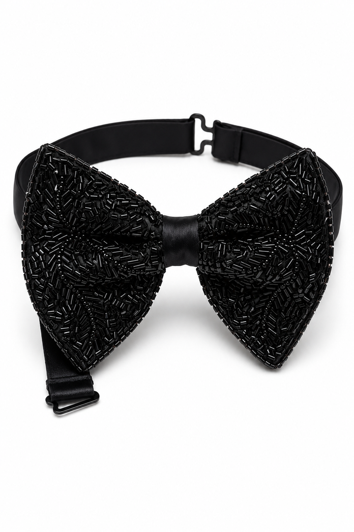 A black bow tie embellished with intricate beaded patterns, featuring a matching black adjustable strap with metal buckles, shown against a plain white background.