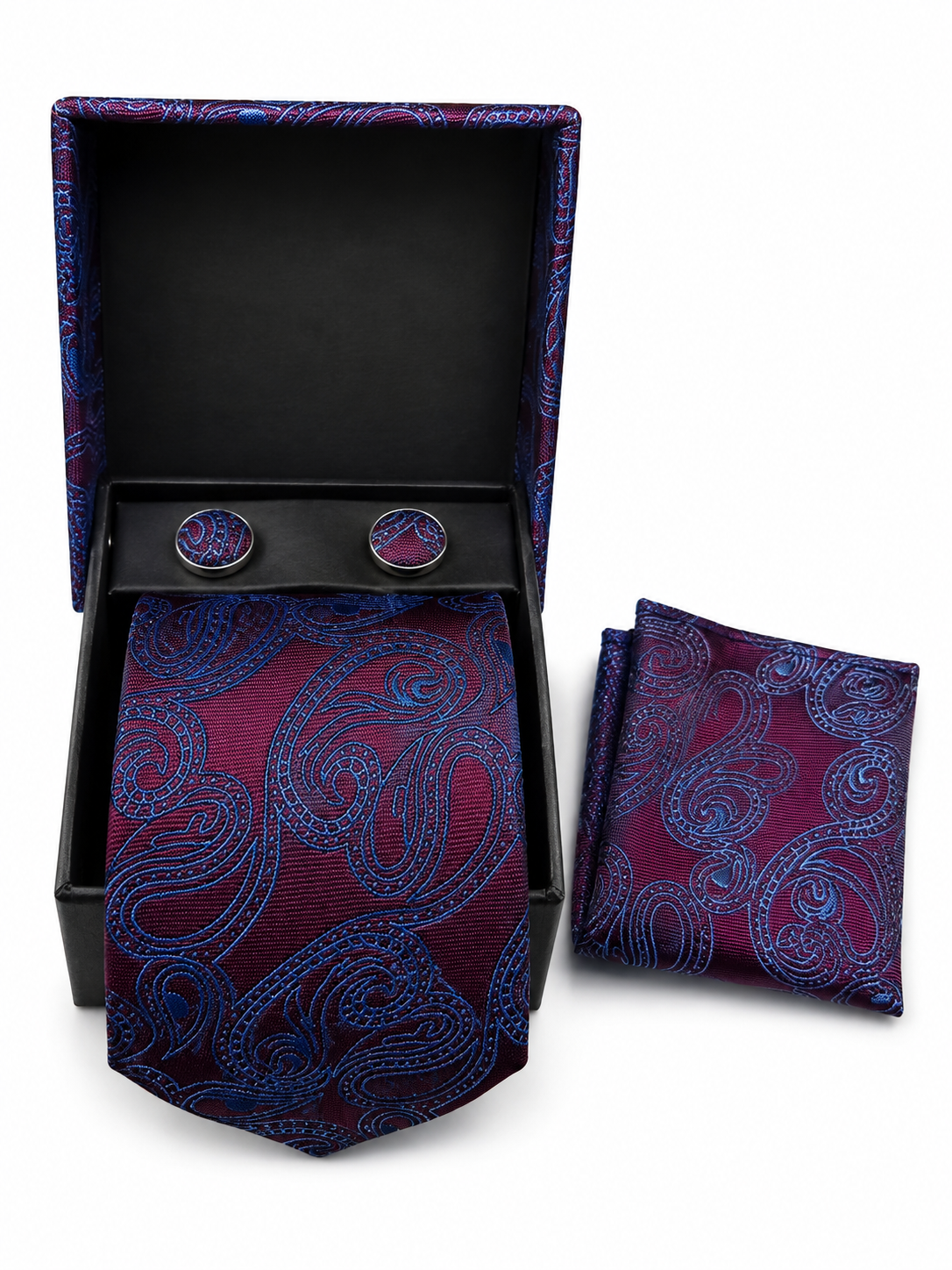 A men's necktie and matching pocket square set with round cufflinks, displayed in an open black gift box on a white background. The fabric features a detailed paisley pattern in deep burgundy and bright blue.