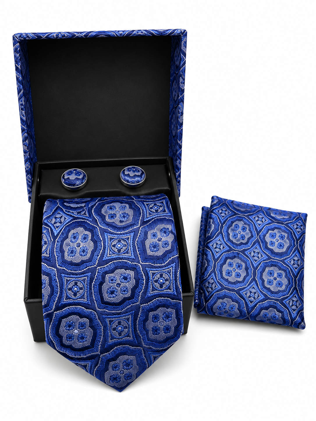 A men's necktie and matching pocket square set with round tie clips, displayed in an open black presentation box on a white background. The fabric features an intricate geometric medallion pattern in shades of royal blue, navy, and light blue.